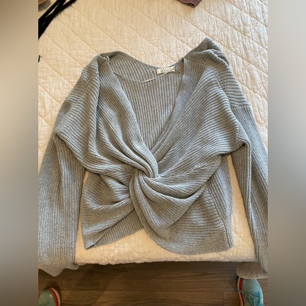 Small, grey long sleeve sweater